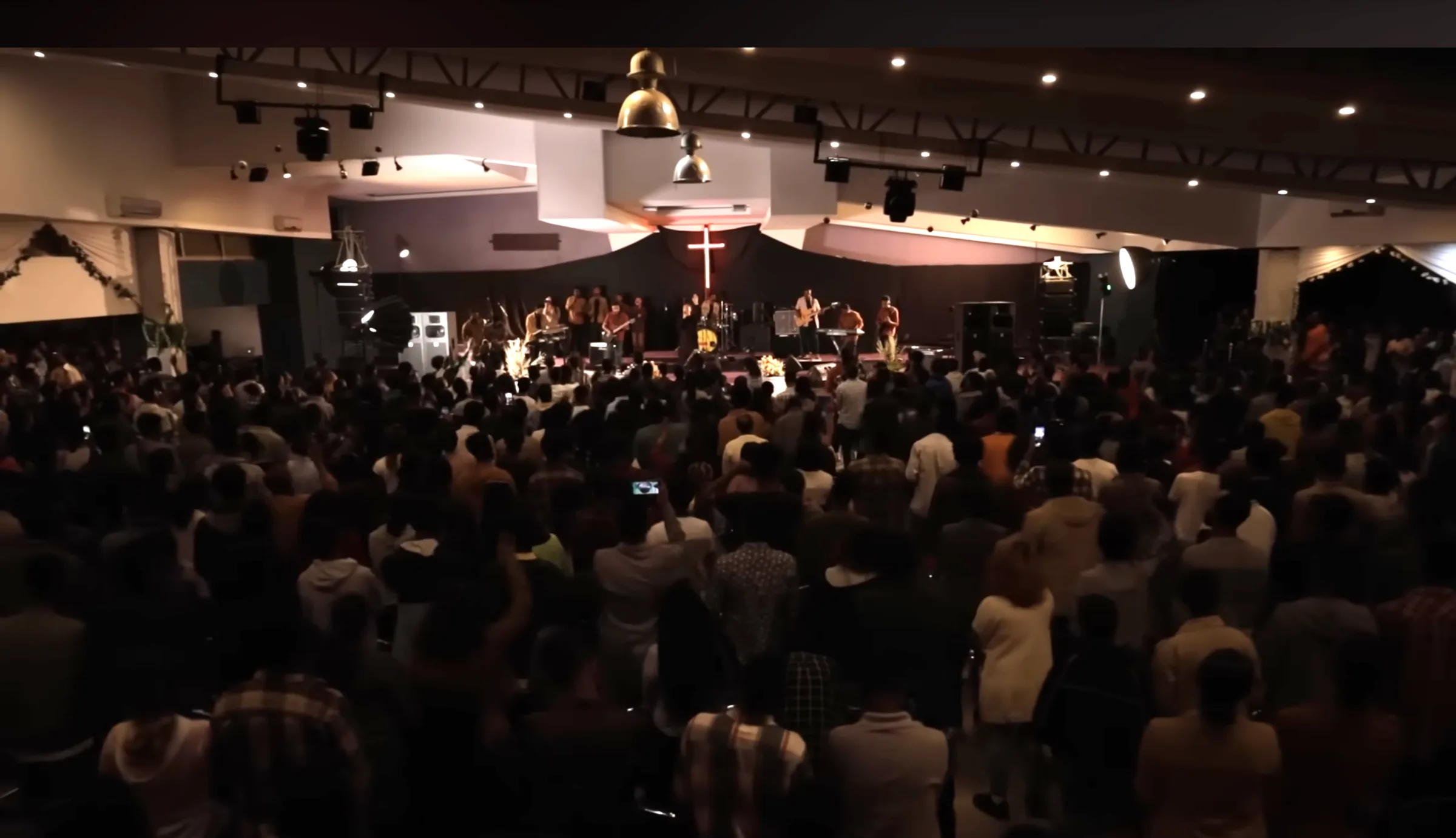 The True Light congregation gathered for worship, with the band leading from the platform